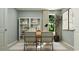 Stylish home office setup with a spacious desk, contemporary chairs, open shelving, and a large leafy plant at 6362 Swainson Street Sw, Ocean Isle Beach, NC 28469