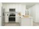 Modern kitchen features white cabinets, stainless steel appliances, and a stylish island at 6362 Swainson Street Sw, Ocean Isle Beach, NC 28469