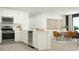 Bright, open kitchen with stainless appliances flows into a dining area with seating for six at 6362 Swainson Street Sw, Ocean Isle Beach, NC 28469