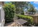 Back porch with a metal table and chairs, overlooking the backyard and fence at 6702 Jefferson Pl. # C6, Myrtle Beach, SC 29572