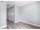Bright bedroom with a hardwood floors, neutral walls, baseboard trim, closet and doorway leading to the rest of the home at 6702 Jefferson Pl. # C6, Myrtle Beach, SC 29572
