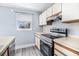 Updated kitchen featuring modern appliances, white cabinets, countertops and a large window for natural light on a sunny day at 6702 Jefferson Pl. # C6, Myrtle Beach, SC 29572