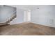 A living room featuring plush carpeting, stairs and neutral paint at 6702 Jefferson Pl. # C6, Myrtle Beach, SC 29572