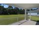 The screened back porch provides great views to the spacious backyard with beautiful green grass at 727 Rupert Dr, Conway, SC 29526