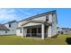 The view of the screened back porch and backyard on a light blue two story home at 727 Rupert Dr, Conway, SC 29526