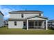 The view of the spacious backyard and the screened back porch on a light blue two story home at 727 Rupert Dr, Conway, SC 29526