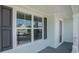 The front porch offers a view from a window with black shutters and light blue siding at 727 Rupert Dr, Conway, SC 29526