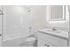 A clean, bright bathroom with shower-tub combo and lighted mirror at 800 Stone Pine Ct., Loris, SC 29569