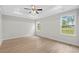 Neutral bedroom with tray ceiling, ceiling fan, and two bright windows at 800 Stone Pine Ct., Loris, SC 29569