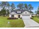 Charming single-Gathering home featuring a well-manicured lawn and a two-car attached garage at 800 Stone Pine Ct., Loris, SC 29569