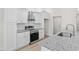 Modern kitchen features stainless steel appliances, granite countertops, and white cabinetry at 800 Stone Pine Ct., Loris, SC 29569