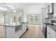 Spacious kitchen with island, stainless steel appliances, white cabinets and ample natural light at 800 Stone Pine Ct., Loris, SC 29569