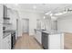 Bright kitchen island boasts granite countertops, stainless steel dishwasher, and a stainless steel sink at 800 Stone Pine Ct., Loris, SC 29569