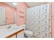 Clean bathroom with a patterned shower curtain, mirror, vanity, and good lighting at 820 Fairway Dr. # 1502Hh, Longs, SC 29568