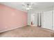 Spacious bedroom with an adjoining bathroom, ceiling fan, and neutral carpeting at 820 Fairway Dr. # 1502Hh, Longs, SC 29568