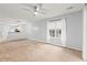 Bright living area featuring carpet, a ceiling fan, and natural light from a window at 820 Fairway Dr. # 1502Hh, Longs, SC 29568