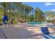 Outdoor pool area with lounge chairs, umbrellas, and lush landscaping for relaxation and enjoyment at 820 Fairway Dr. # 1502Hh, Longs, SC 29568