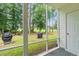 Relaxing screened porch with view of the backyard, golf course, and two grills at 820 Fairway Dr. # 1502Hh, Longs, SC 29568