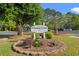 Welcome to Colonial Creek I & II Golf Resorts sign with landscaping and mature trees at 820 Fairway Dr. # 1502Hh, Longs, SC 29568