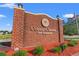 Colonial Charters Golf Community brick sign with manicured landscaping and an American flag at 820 Fairway Dr. # 1502Hh, Longs, SC 29568