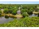 Stunning aerial view of a waterfront home surrounded by lush trees and a serene lake setting at 95 Sanderling Ave., Georgetown, SC 29440