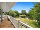 Scenic back deck overlooking a peaceful pond with lush landscaping, ideal for enjoying nature and relaxation at 95 Sanderling Ave., Georgetown, SC 29440