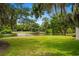 Lush backyard with a tranquil pond and manicured lawn, offering a private and picturesque setting for outdoor enjoyment at 95 Sanderling Ave., Georgetown, SC 29440