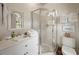 Bright bathroom featuring a vanity with sink, a glass shower, and tiled floors at 95 Sanderling Ave., Georgetown, SC 29440