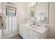 Bright bathroom with a double vanity, marble countertops, and natural light from a window with white shutters at 95 Sanderling Ave., Georgetown, SC 29440
