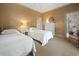 Bedroom features twin beds, neutral walls, and an attached bathroom for convenience at 95 Sanderling Ave., Georgetown, SC 29440