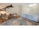 Spacious bedroom with an eye-catching marlin wall decor and a large oriental rug at 95 Sanderling Ave., Georgetown, SC 29440
