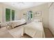 Bright bedroom features two twin beds, shuttered windows, and carpeted floors at 95 Sanderling Ave., Georgetown, SC 29440