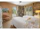 Comfortable bedroom featuring twin beds, shuttered windows, built-in bookshelves and an arched window at 95 Sanderling Ave., Georgetown, SC 29440