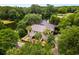 Beautiful home exterior featuring palm trees, well manicured garden, white stairs and metal roof at 95 Sanderling Ave., Georgetown, SC 29440