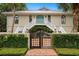 Beautiful home featuring a charming gated entrance with brick pathway and lush greenery at 95 Sanderling Ave., Georgetown, SC 29440