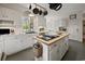 Well-lit kitchen featuring an island with cooktop, white cabinets, and stainless-steel appliances at 95 Sanderling Ave., Georgetown, SC 29440