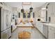 Bright kitchen featuring white cabinets, an island, stainless steel appliances, and hanging lights at 95 Sanderling Ave., Georgetown, SC 29440