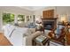 Cozy living area with a fireplace, plush white seating, and natural light streaming in at 95 Sanderling Ave., Georgetown, SC 29440