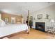 Sunlit main bedroom featuring a cozy fireplace, neutral tones and four poster bed at 95 Sanderling Ave., Georgetown, SC 29440