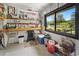 Organized workshop featuring a workbench, storage shelves, and a large window overlooking a serene lakeside view at 95 Sanderling Ave., Georgetown, SC 29440