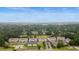An aerial view showcases the complex, lake, and surrounding greenery at 100 Lazy Willow Ln. # 103, Myrtle Beach, SC 29588