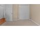 Bedroom with carpet, white trim, and a closet, offering a simple and clean aesthetic at 100 Lazy Willow Ln. # 103, Myrtle Beach, SC 29588