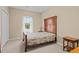 Cozy bedroom with neutral walls, carpet, a window, and classic wood furniture at 100 Lazy Willow Ln. # 103, Myrtle Beach, SC 29588