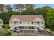Inviting two-story condo with tan siding, green shutters, white stairs, and ample parking at 100 Lazy Willow Ln. # 103, Myrtle Beach, SC 29588