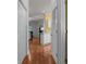 Hallway with wood floors leading to a bright living area and a glimpse of a yellow wall at 100 Lazy Willow Ln. # 103, Myrtle Beach, SC 29588