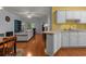 Open-concept living area featuring hardwood floors, a ceiling fan, and views into the kitchen at 100 Lazy Willow Ln. # 103, Myrtle Beach, SC 29588