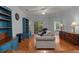Cozy living room featuring hardwood floors, a comfortable couch, and sliding glass door at 100 Lazy Willow Ln. # 103, Myrtle Beach, SC 29588