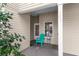 Cozy covered patio with a teal chair, small table, and a glimpse of the home's entrance at 100 Lazy Willow Ln. # 103, Myrtle Beach, SC 29588