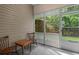 View of the screened porch with outdoor furniture and lattice screen overlooking greenery at 100 Lazy Willow Ln. # 103, Myrtle Beach, SC 29588