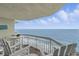 Cozy balcony features Adirondack chairs and a table, perfect for enjoying ocean views at 1012 N Waccamaw Dr. # 1107, Murrells Inlet, SC 29576